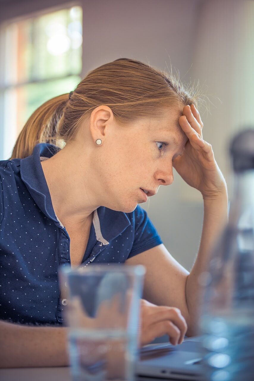 frustrated woman looking at bills