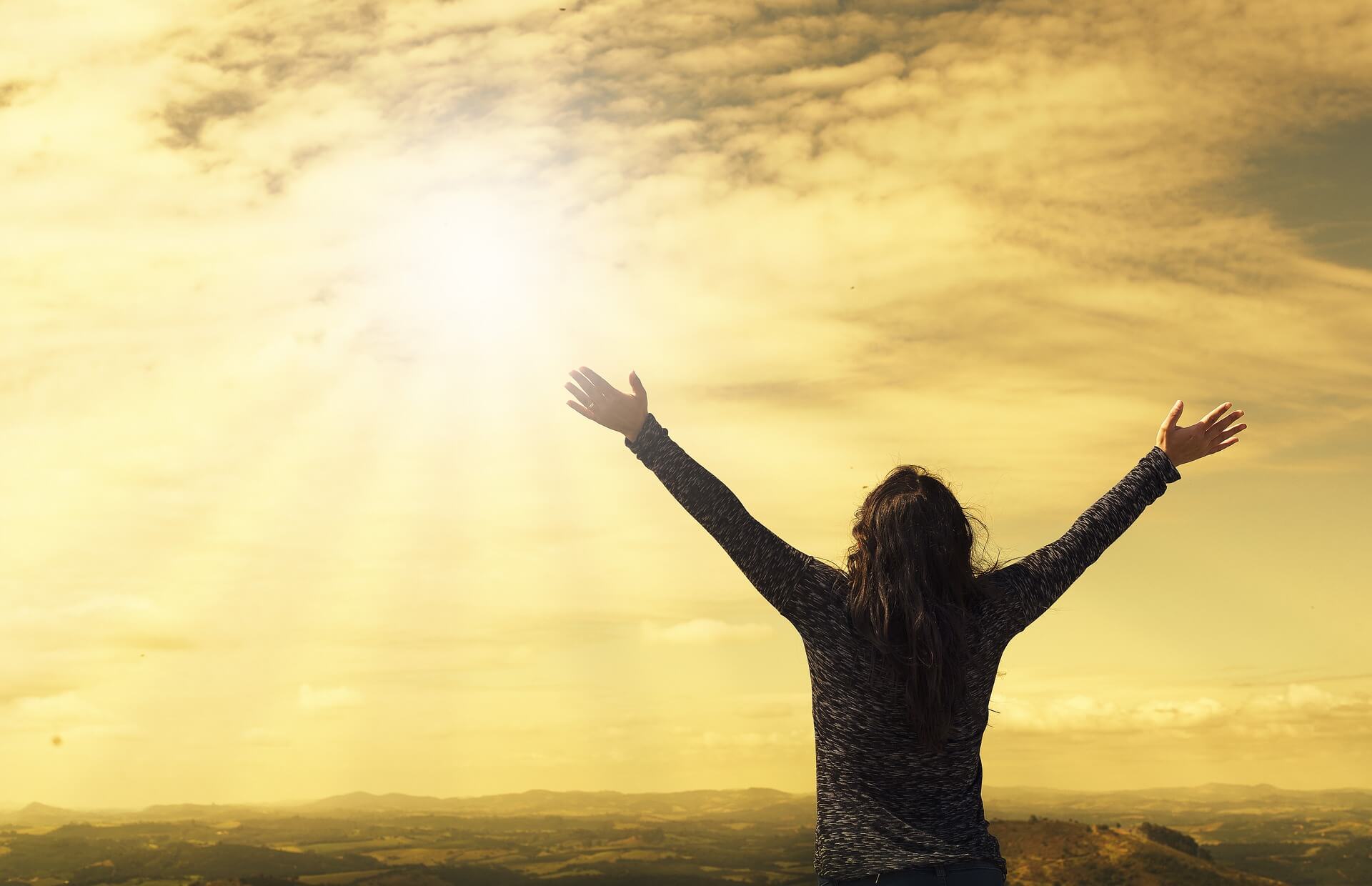 Relieved person raising arms in freedom