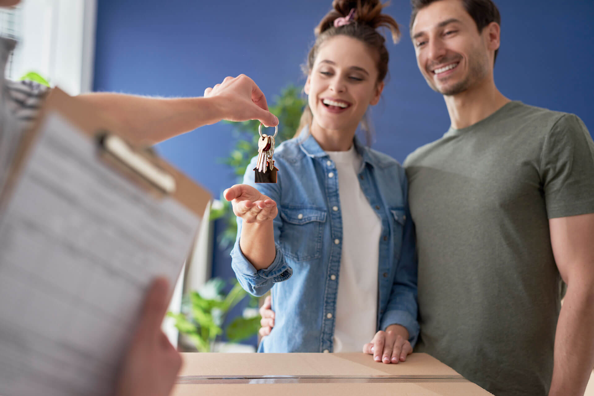 happy couple getting keys to home