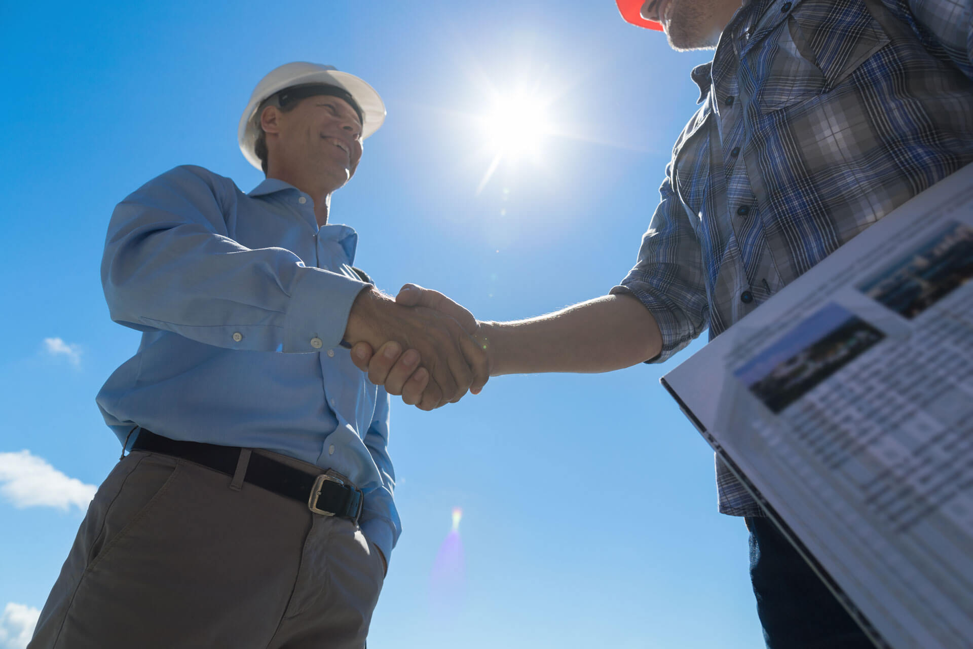 men shaking hands on construction site